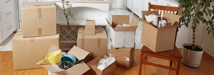 Packed moving boxes and household items in a kitchen before move-out or move-in cleaning, Hialeah, FL.